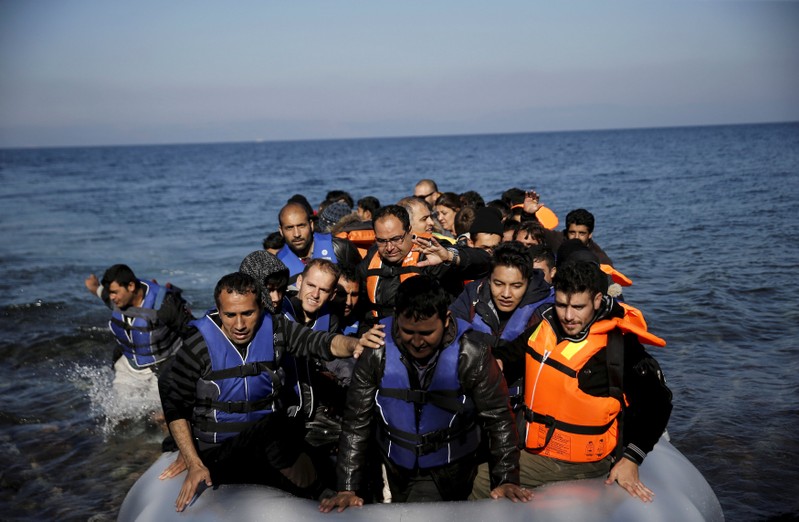 FILE PHOTO: Refugees and migrants arrive on a raft on the Greek island of Lesbos