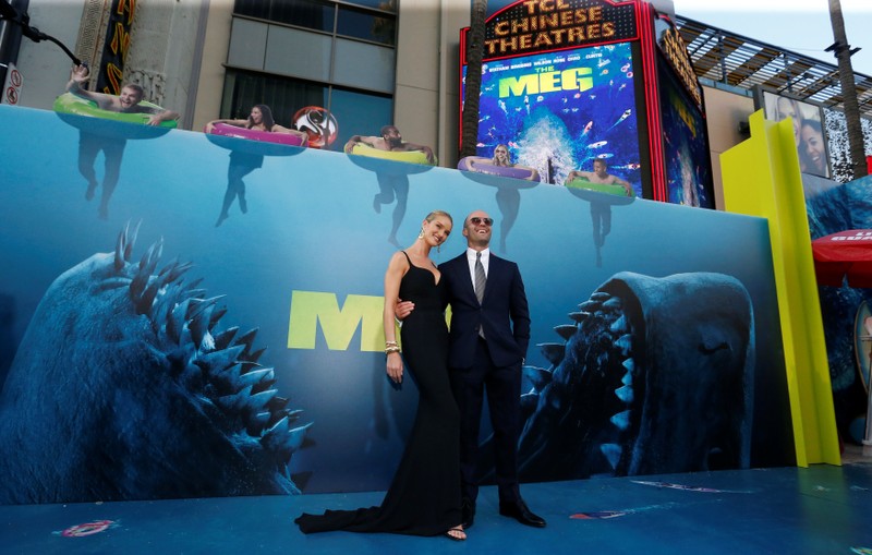 Cast member Statham and model Huntington-Whiteley pose at the premiere for 