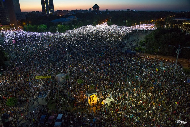 People attend a protest in Bucharest