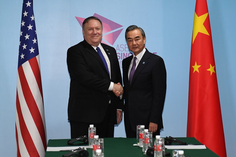 U.S. Secretary of State Mike Pompeo and China's Foreign Minister Wang Yi shake hands before their bilateral meeting at the 51st Association of Southeast Asian Nations (ASEAN) in Singapore
