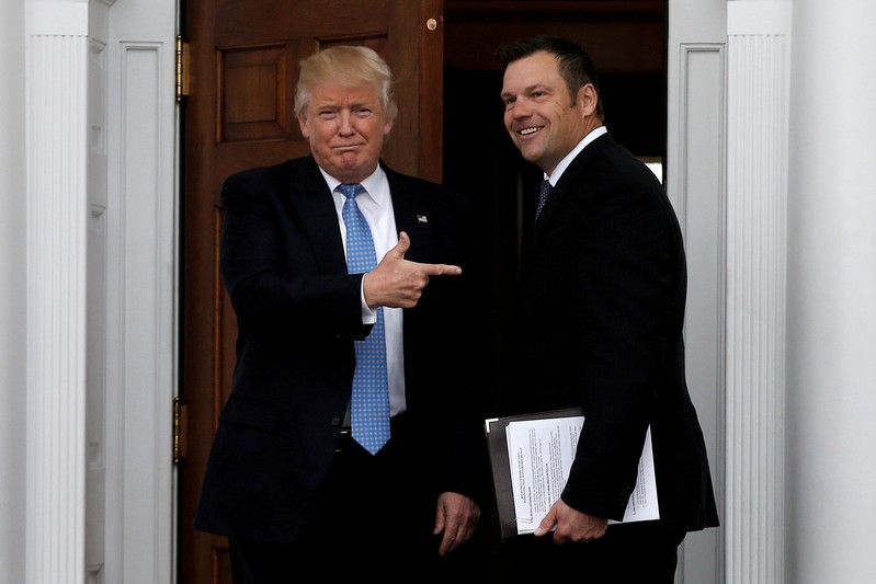 FILE PHOTO: U.S. President-elect Trump stands with Kansas Secretary of State Kobach before their meeting at Trump National Golf Club in Bedminster