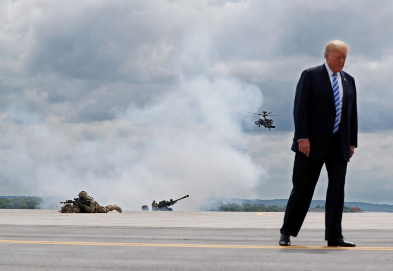 U.S. President Trump observes a demonstration with troops, an attack helicopter and artillery as he visits Fort Drum, New York