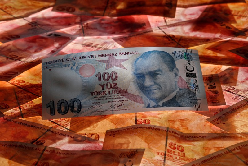 FILE PHOTO: A 100 Turkish lira banknote is seen on top of 50 Turkish lira banknotes in this picture illustration in Istanbul