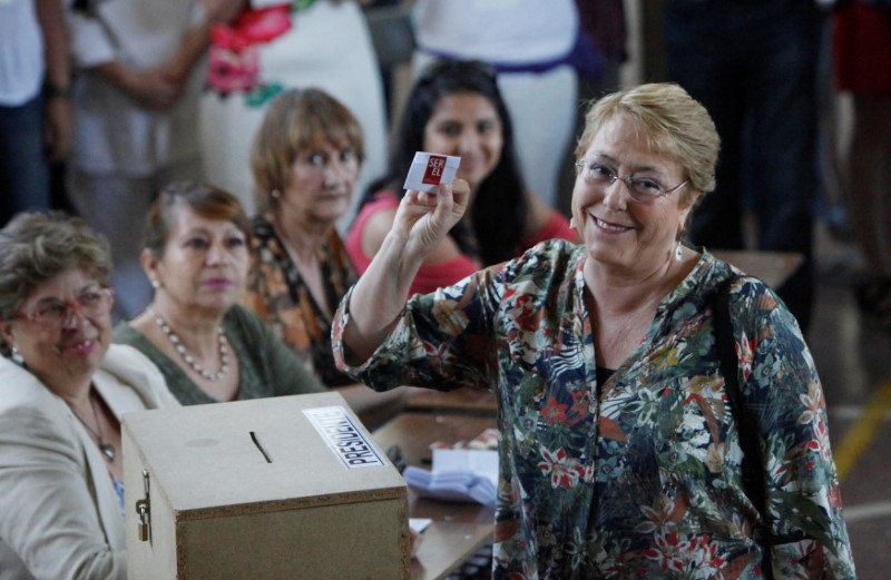 Chilean president Michelle Bachelet shows her ballot during the presidential election in Santiago