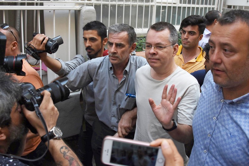 FILE PHOTO: U.S. pastor Andrew Brunson reacts as he arrives at his home after being released from the prison in Izmir