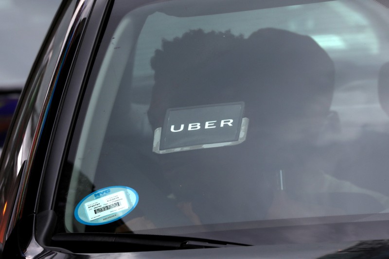 FILE PHOTO: An Uber logo is seen on a car a as it car drives through Times Square in New York City