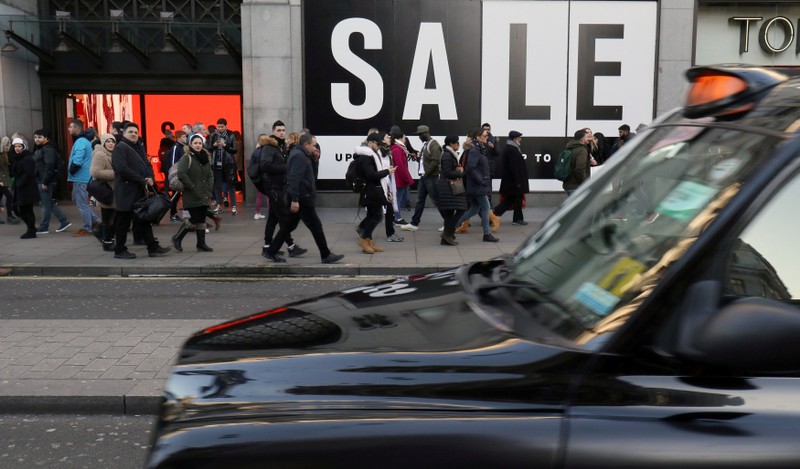 FILE PHOTO: Shoppers and tourists walk along Oxford Street during the sales in central London, Britain