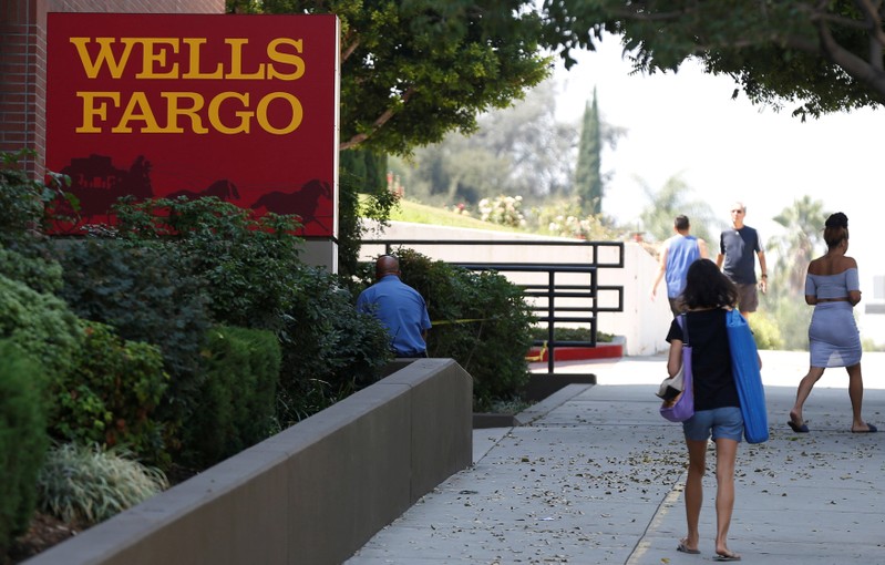 FILE PHOTO: People walk by a Wells Fargo banking location in Pasadena