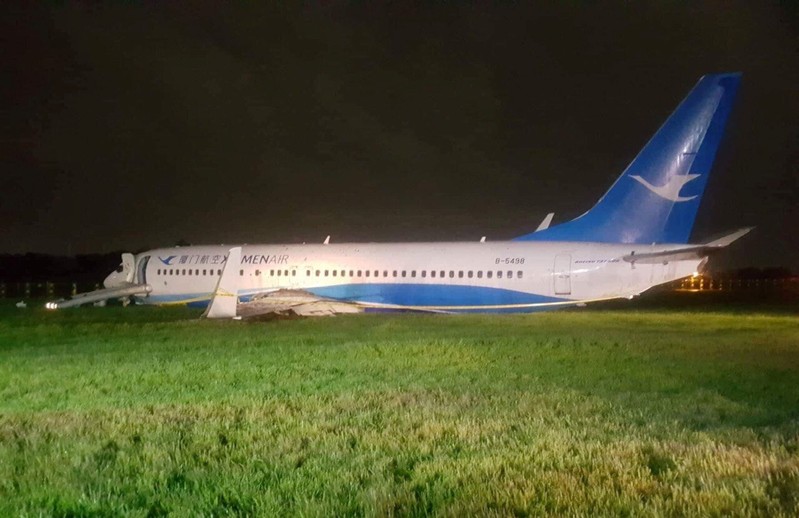 A Xiamen Airlines Boeing 737-800 is pictured next to airport perimeter fence after it overshot the runway at Ninoy Aquino International airport in Paranaque, Metro Manila