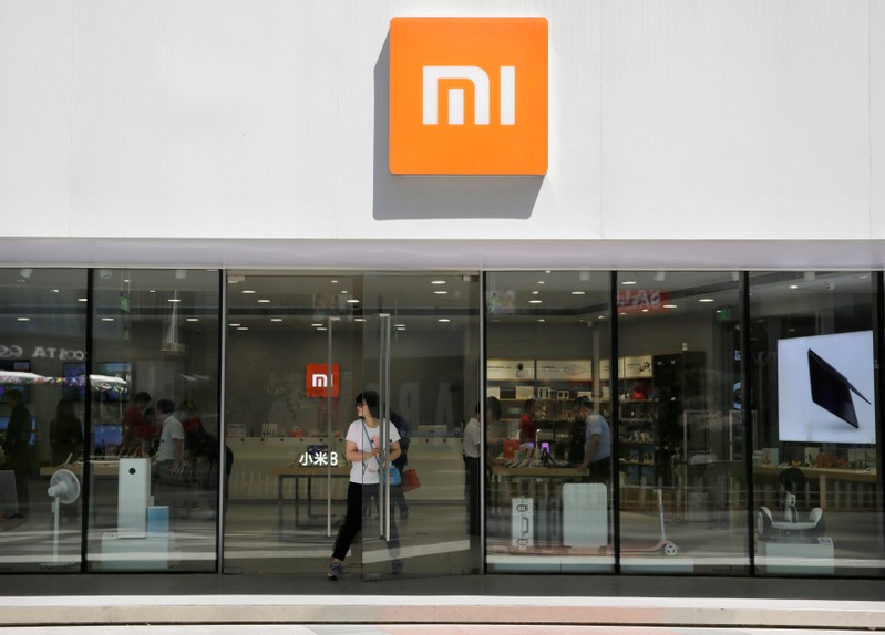 FILE PHOTO: A customer walks out of a Xiaomi store in Beijing