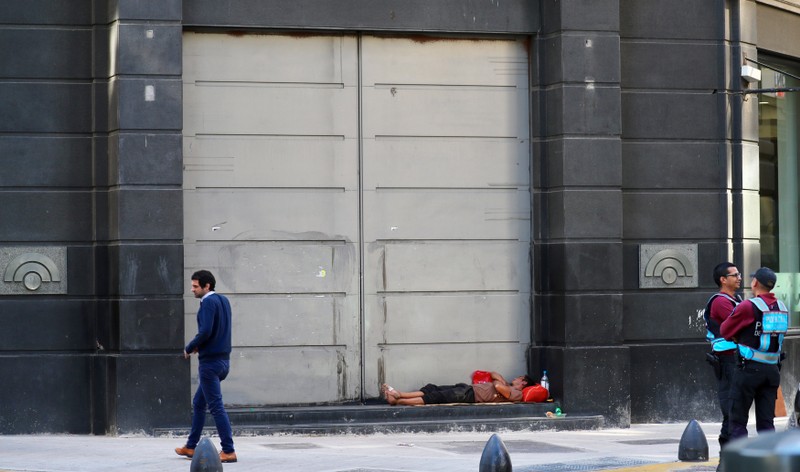 A man sleeps outside a bank in Buenos Aires' financial district