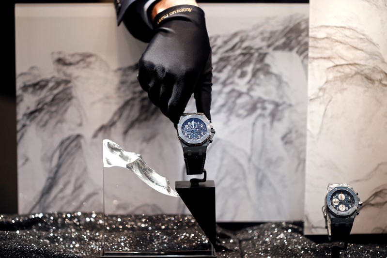 FILE PHOTO: A salesman displays a high-end watch at an Audemars Piguet boutique in Manama