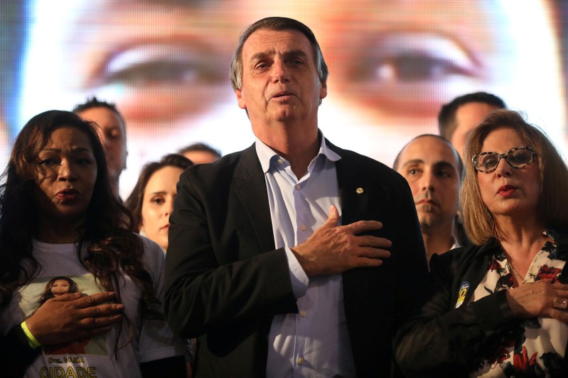 FILE PHOTO: Presidential candidate Jair Bolsonaro listens to the national anthem during a meeting with women in Porto Alegre