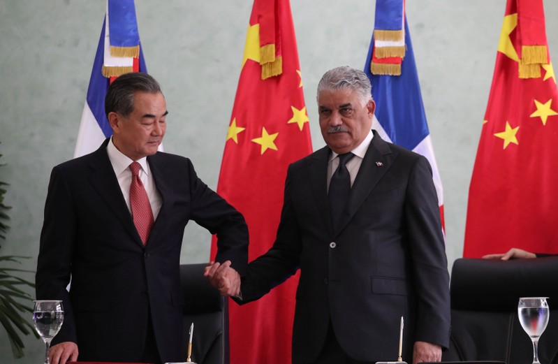 China's Foreign Minister Wang Yi and Dominican Republic's Chancellor Miguel Vargas shake hands after signing a bilateral agreement in Santo Domingo