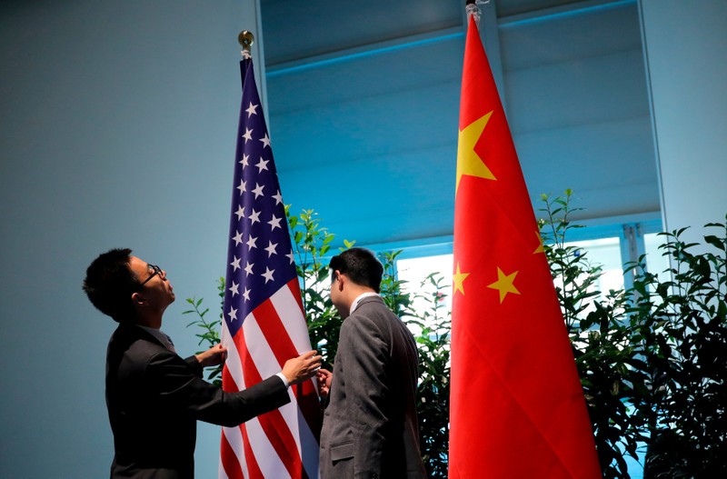 FILE PHOTO: Chinese officials prepare the flags for the China-U.S. bilateral meeting at the G20 leaders summit in Hamburg