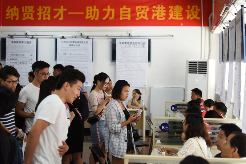 FILE PHOTO: Job seekers attend a job fair at the Human Resources Development Bureau of Hainan province in Haikou