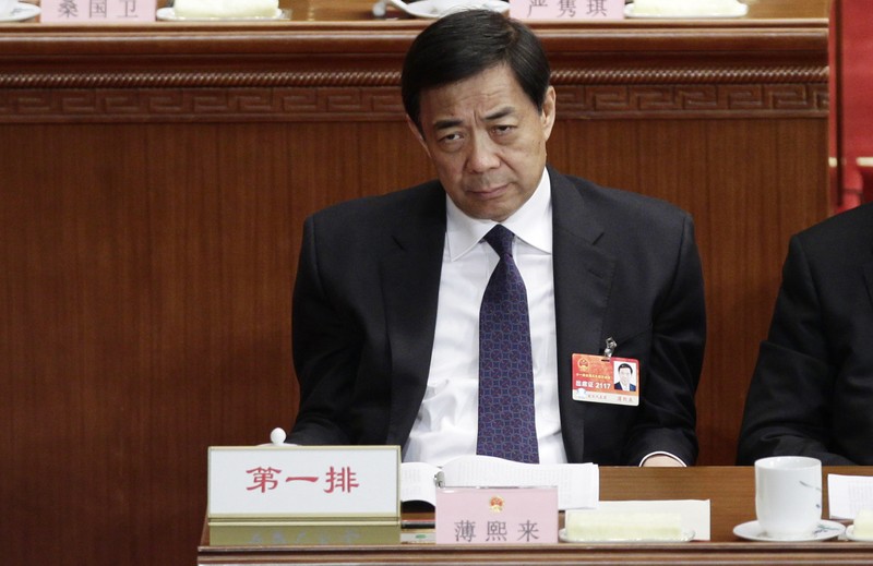 Former China's Chongqing Municipality Communist Party Secretary Bo Xilai pauses as he attends a plenary meeting of China's parliament, the National People's Congress, at the Great Hall of the People in Beijing