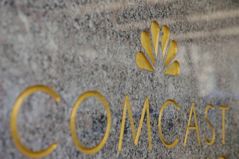 FILE PHOTO: The NBC and Comcast logos are displayed on 30 Rockefeller Plaza in midtown Manhattan in New York