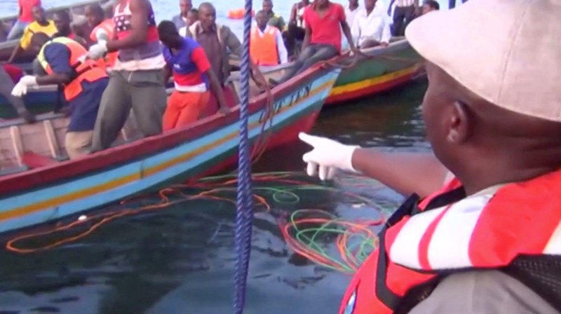 Rescue workers are seen at the scene where a ferry overturned in Lake Victoria