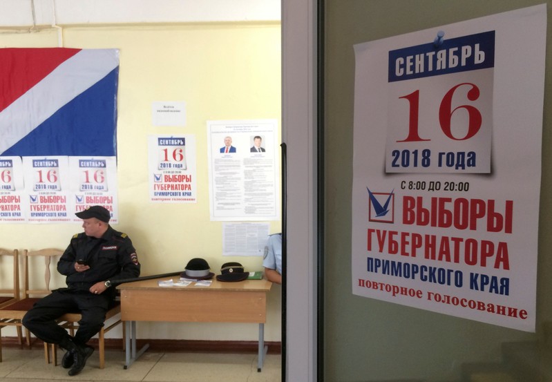 FILE PHOTO: A policeman guards a polling station during the gubernatorial election in Vladivostok