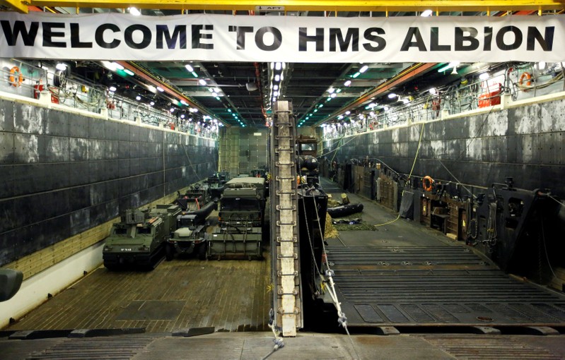 FILE PHOTO: Military vehicles are seen in the loading dock of the HMS Albion, the British Royal Navy flagship amphibious assault ship, after the ship's arrival at Harumi Pier in Tokyo