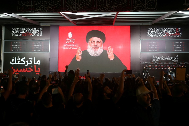 Lebanon's Hezbollah leader Sayyed Hassan Nasrallah gestures as he addresses his supporters via a screen the night before Muslim Shi'ites around the world mark the day of Ashura, in Beirut