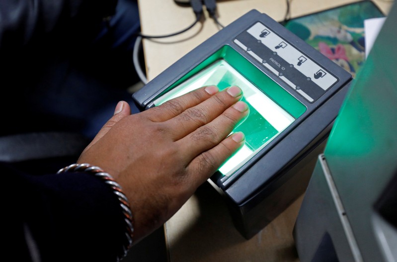 FILE PHOTO: A woman goes through the process of finger scanning for the UID database system, also known as Aadhaar, at a registration centre in New Delhi