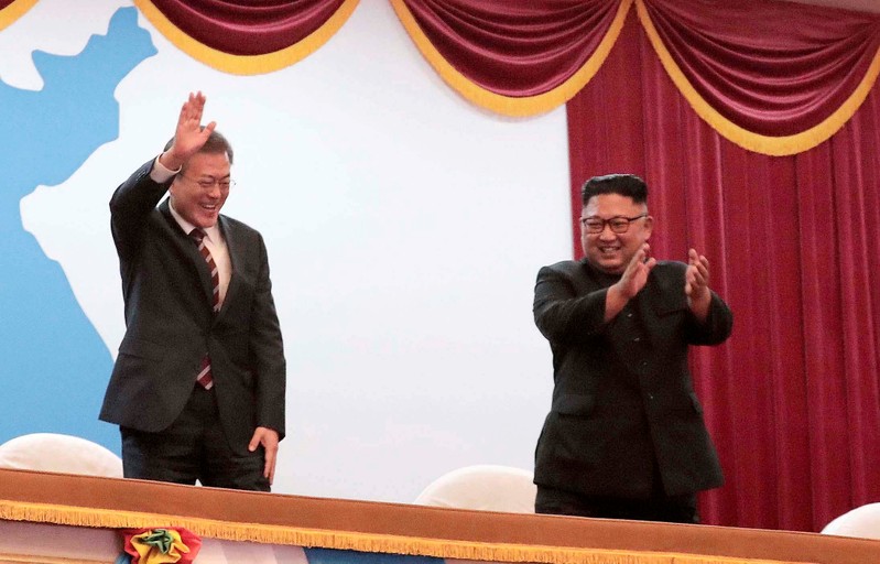 South Korean President Moon Jae-in talks with North Korean leader Kim Jong Un as they watch an art performance at Pyongyang Grand Theatre in Pyongyang