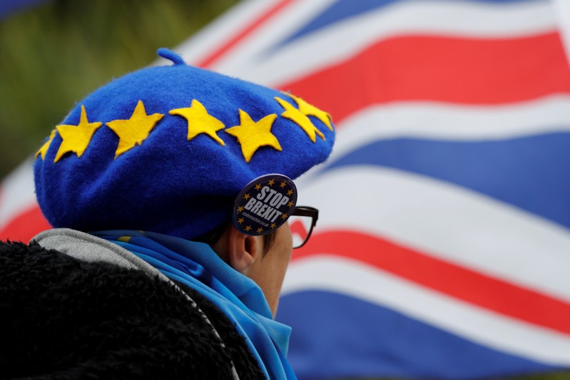 A man wears a beret designed to resemble the EU flag during an anti-Brexit demonstration on the first day of the Conservative Party Conference in Birmingham