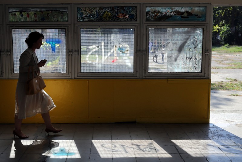 A woman leaves the polling station after casting her ballot for the referendum in Macedonia on changing the country's name that would open the way for it to join NATO and the European Union in Skopje