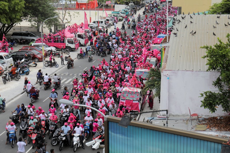 Supporters of the Maldivian President Yameen ride on their bikes during the final campaign march rally ahead of their presidential election in Male