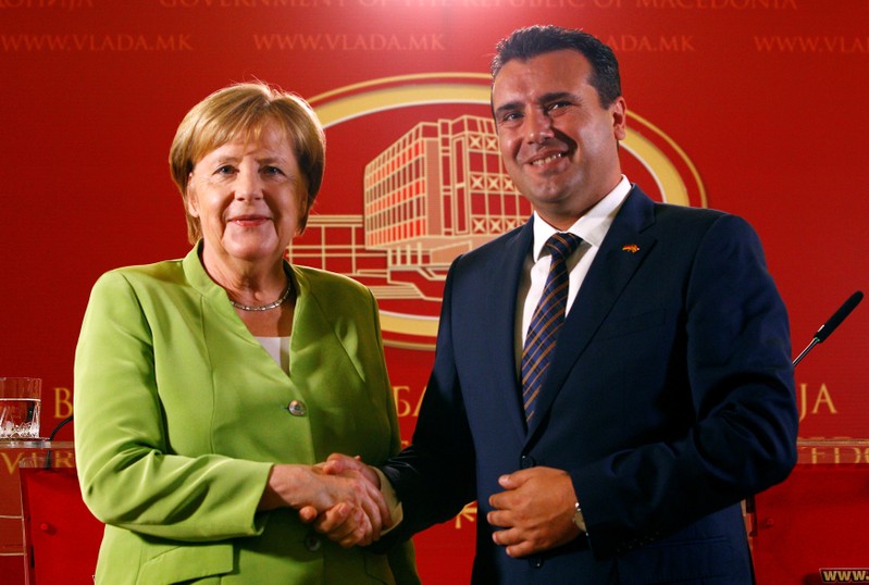 Macedonian Prime Minister Zoran Zaev and German Chancellor Angela Merkel shake hands after a news conference in Skopje