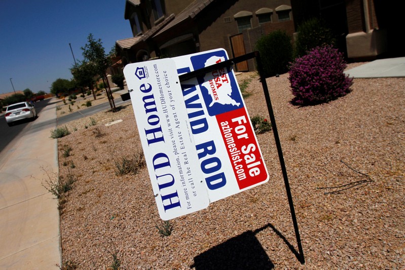 FILE PHOTO: Real estate for sale and Housing and Urban Development signs are displayed outside a home in Chandler Heights, Arizona