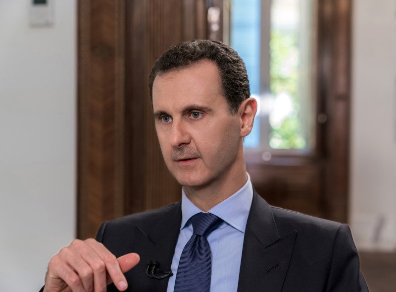 Syrian President Bashar al-Assad attends an interview with Russian television channel NTV