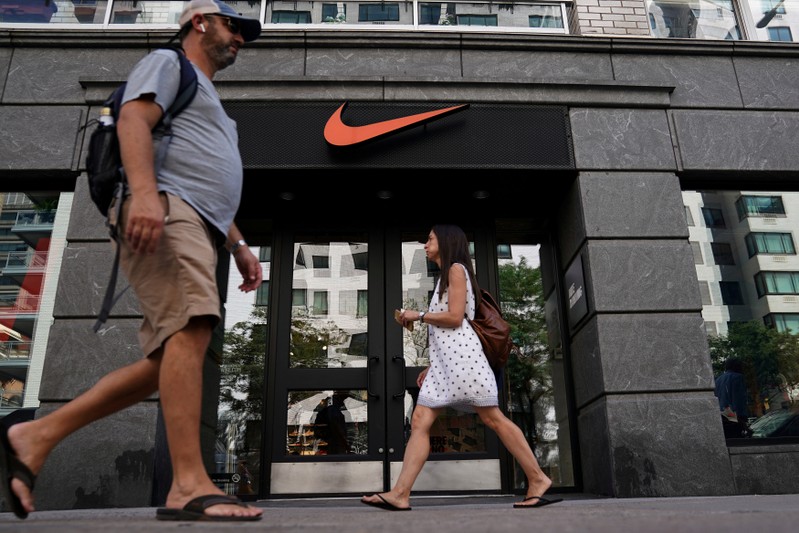 FILE PHOTO: People walk past a Nike store in New York City,