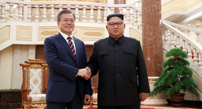 South Korean President Moon Jae-in shakes hands with North Korean leader Kim Jong Un as they arrive for their meeting at the headquarters of the Central Committee of the Workers' Party of Korea in Pyongyang