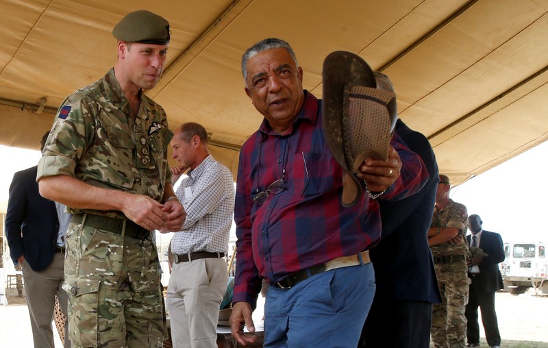 The Duke of Cambridge, Prince William listens to Laikipia Rancher Sammy Jessel during his visit to the British Army Training Unit Kenya in Laikipia