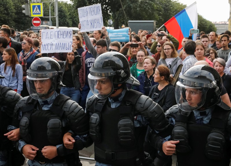Police officers block a street during a rally against planned increases to the nationwide pension age in St. Petersburg