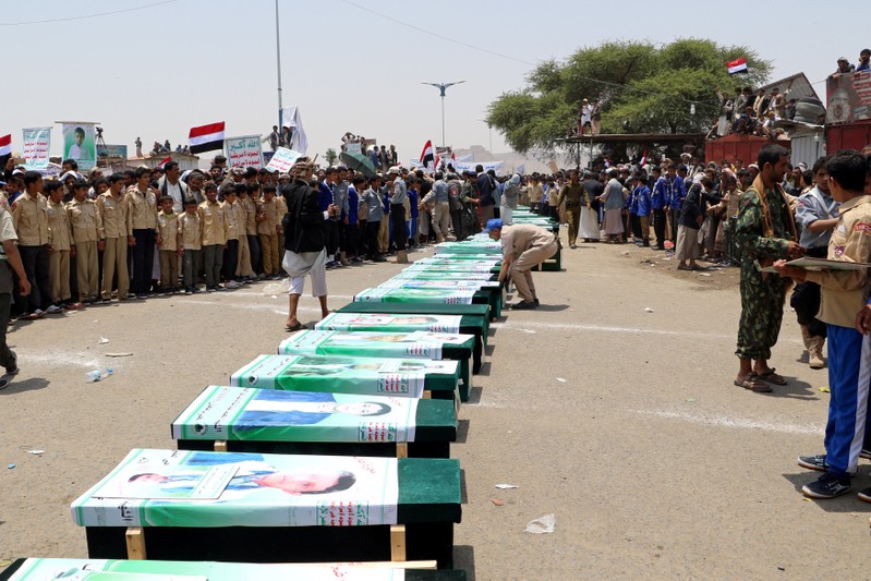 FILE PHOTO: Mourners attend a funeral of people, mainly children, killed in a Saudi-led coalition air strike on a bus in northern Yemen, in Saada