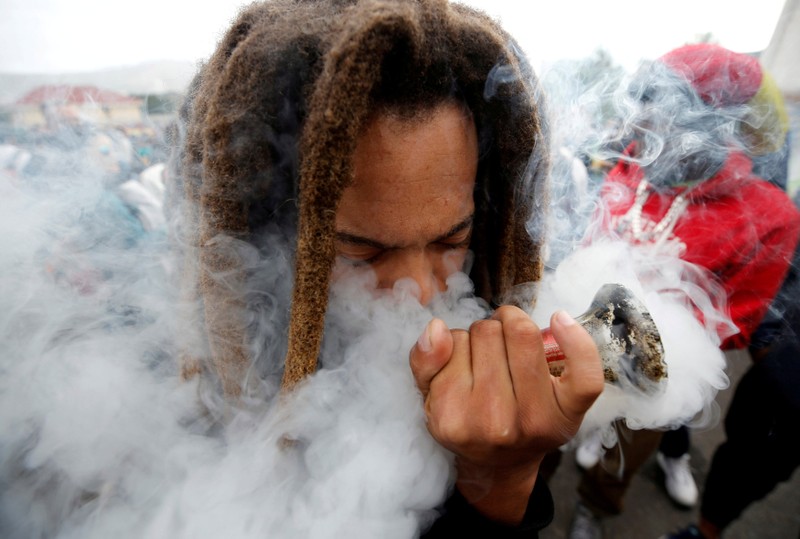 FILE PHOTO: A man smokes marijuana, known locally as dagga, during a march calling for the legalisation of cannabis in Cape Town