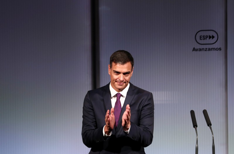 Spain’s PM Sanchez applauds at the end of an event marking the first 100 days of his government in Madrid
