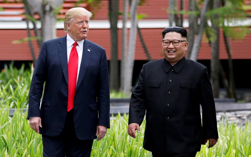 FILE PHOTO: U.S. President Donald Trump and North Korean leader Kim Jong Un walk after lunch at the Capella Hotel on Sentosa island in Singapore