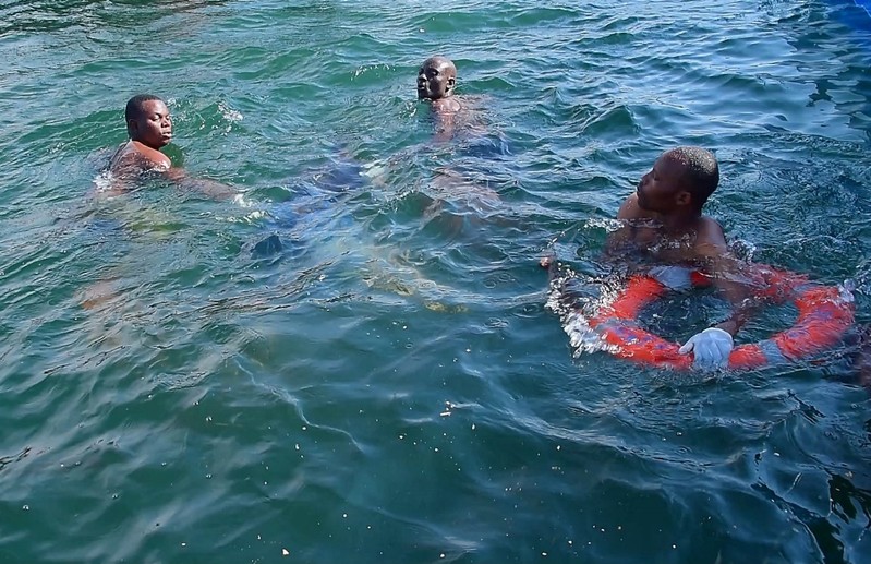 Rescuers search for bodies in the water after a ferry overturned off the shores of Ukerewe Island in Lake Victoria
