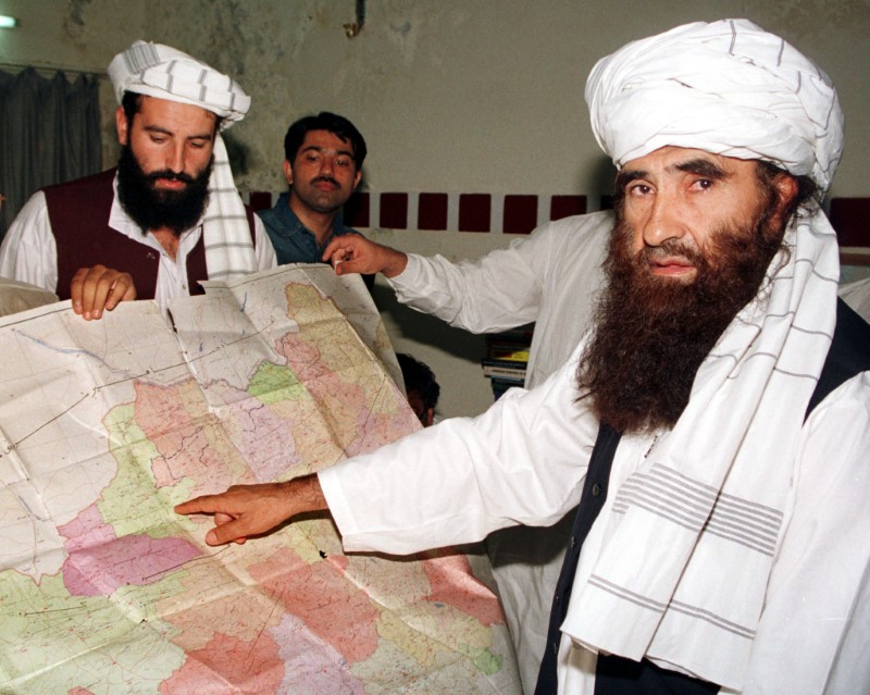 Jalaluddin Haqqani (R), the Taliban's Minister for Tribal Affairs, points to a map of Afghanistan du..