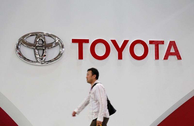 A man walks past a Toyota Motor Corp logo at the company's showroom in Tokyo