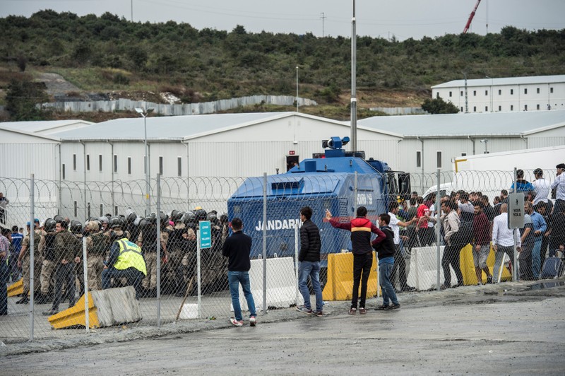 Turkish Gendarmes surround workers during a protest against the labor conditions at the construction site of the city's new airport in Istanbul