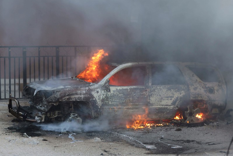 A car burns at the scene of an explosion in Mogadishu