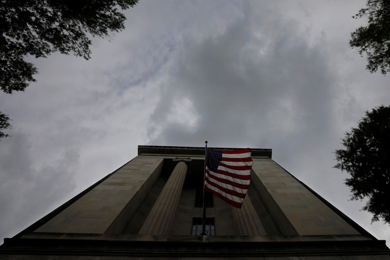 A U.S. flag flies at the headquarters of the Department of Justice in Washington