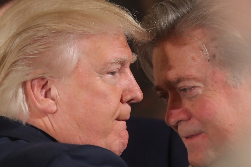 FILE PHOTO - U.S. President Donald Trump talks to senior staff Steve Bannon during a swearing in ceremony for senior staff at the White House in Washington, DC