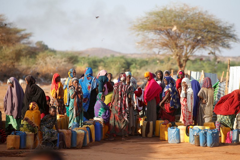 FILE PHOTO: Somali women wait to collect water at the New Kabasa Internally displaced camp in the northern Somali town of Dollow